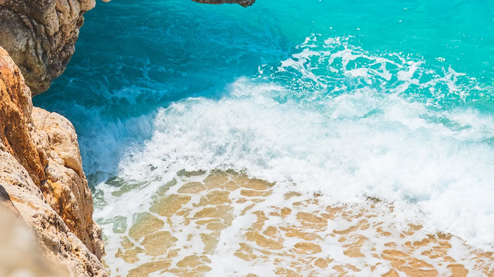 Rocky cliffs and turquoise sea on the Lara coast of Antalya