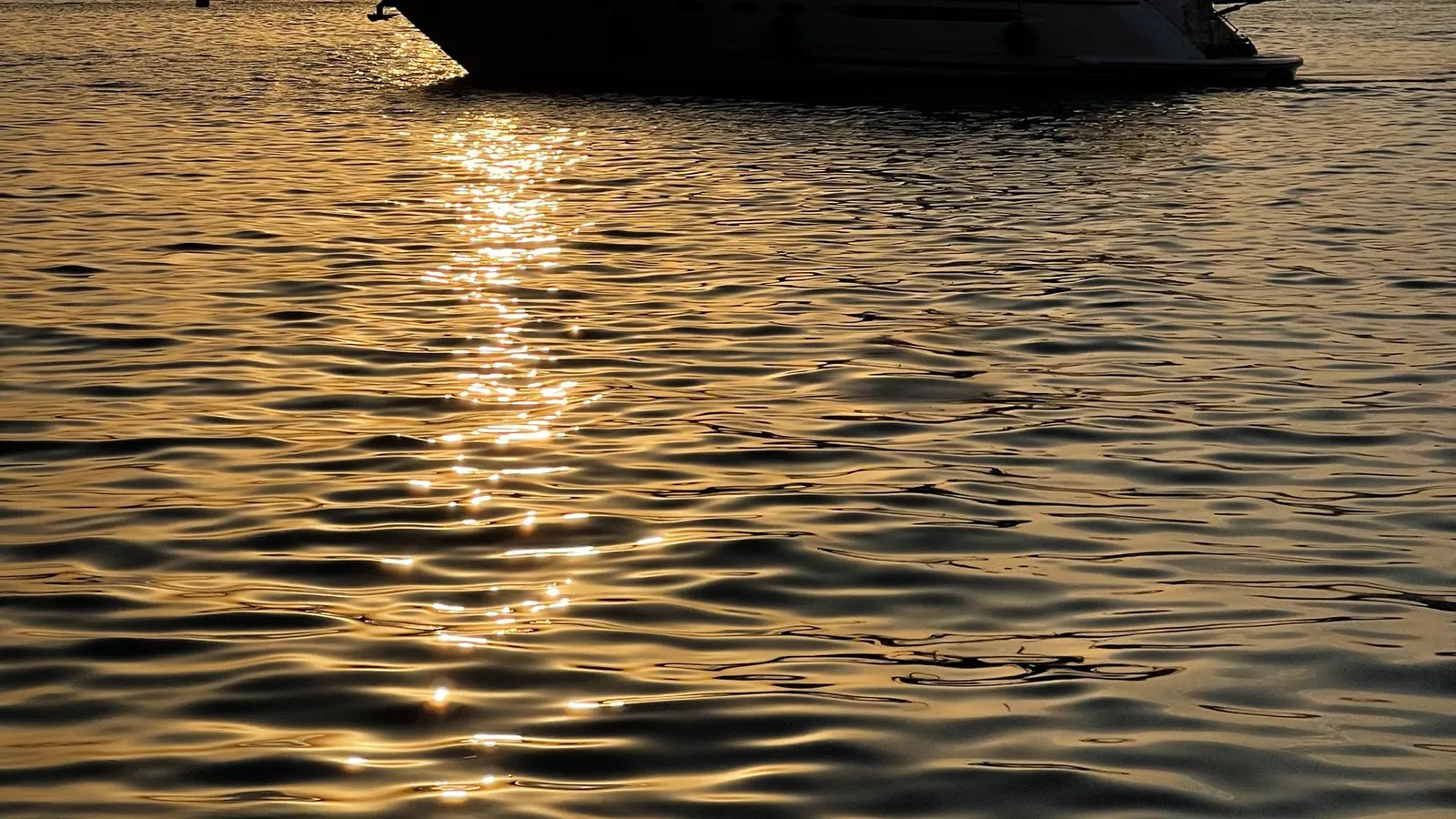 Yachts on calm water at sunset off Turgutreis, Bodrum peninsula