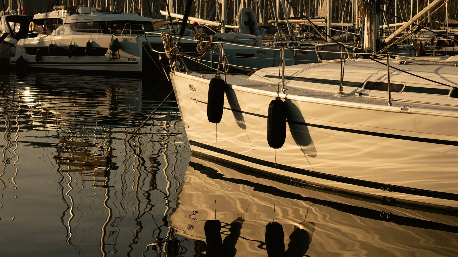 Sailboats moored in Fethiye marina at dusk