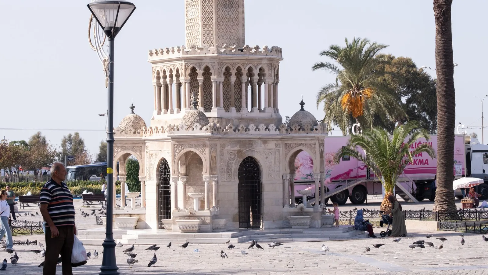 Konak clock tower surrounded by palm trees in Izmir